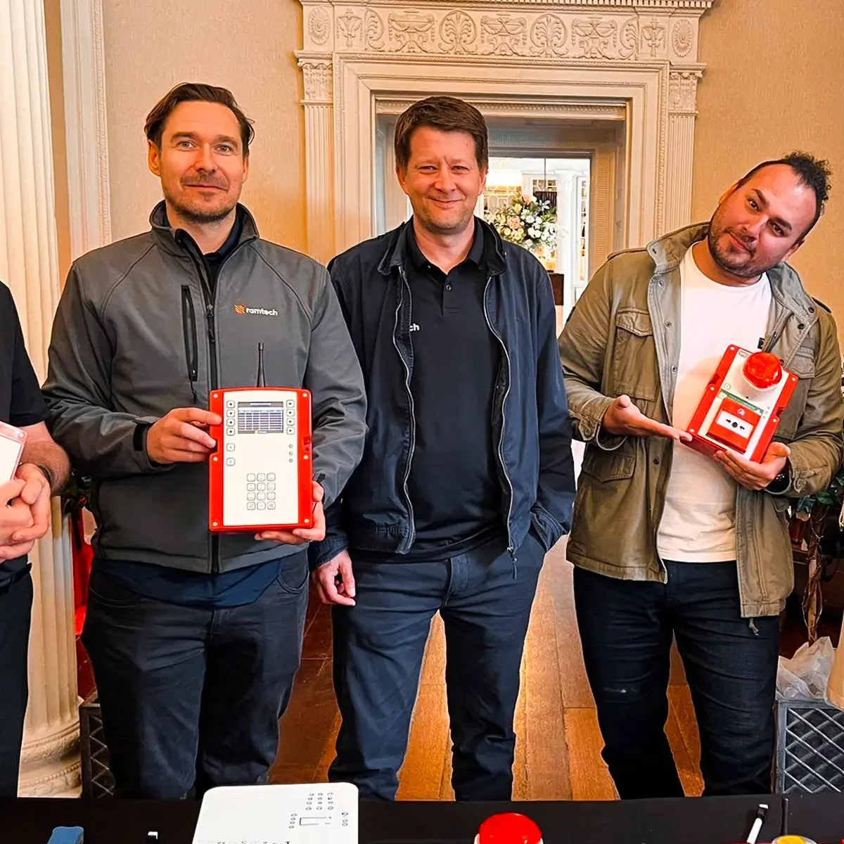 Ramtech People & Culture team holding WES wireless safety devices